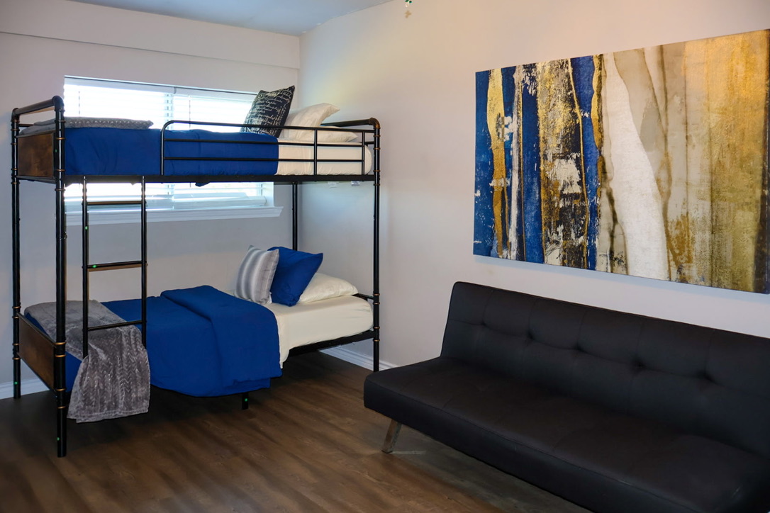 A shared guest room with a bunk bed and seating